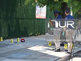 NYPD crime scene investigators search for and collect evidence at the scene outside Wave Juice Bar and Lounge where a 31-year-old man is kil...