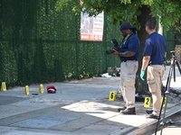 NYPD crime scene investigators search for and collect evidence at the scene outside Wave Juice Bar and Lounge where a 31-year-old man is kil...