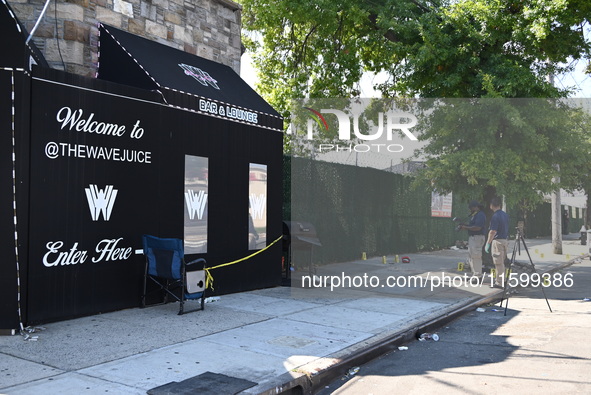 NYPD crime scene investigators search for and collect evidence at the scene outside Wave Juice Bar and Lounge where a 31-year-old man is kil...