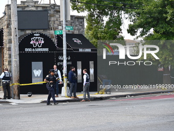 NYPD crime scene investigators search for and collect evidence at the scene outside Wave Juice Bar and Lounge where a 31-year-old man is kil...