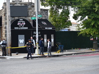 NYPD crime scene investigators search for and collect evidence at the scene outside Wave Juice Bar and Lounge where a 31-year-old man is kil...