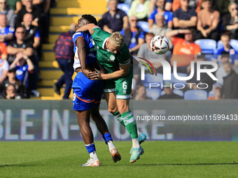 Mike Fondop of Oldham Athletic Association Football Club tussles with Jake Wannell of Yeovil Town Football Club during the Vanarama National...