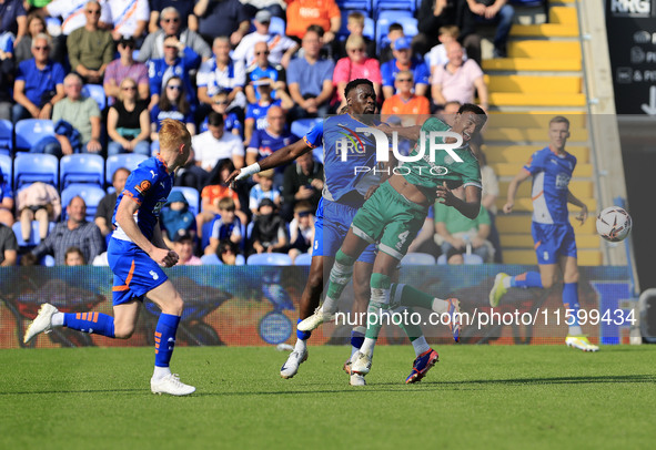 Mike Fondop of Oldham Athletic Association Football Club tussles with Morgan Williams of Yeovil Town Football Club during the Vanarama Natio...