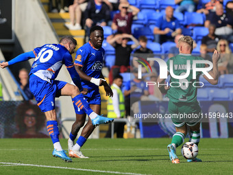 James Norwood of Oldham Athletic Association Football Club has a shot blocked by Jake Wannell of Yeovil Town Football Club during the Vanara...