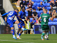 James Norwood of Oldham Athletic Association Football Club has a shot blocked by Jake Wannell of Yeovil Town Football Club during the Vanara...