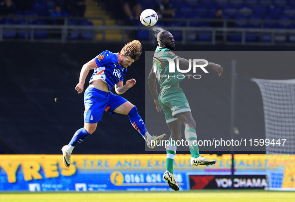 Reagan Ogle of Oldham Athletic Association Football Club tussles with Frank Nouble of Yeovil Town Football Club during the Vanarama National...