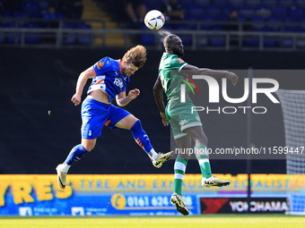 Reagan Ogle of Oldham Athletic Association Football Club tussles with Frank Nouble of Yeovil Town Football Club during the Vanarama National...