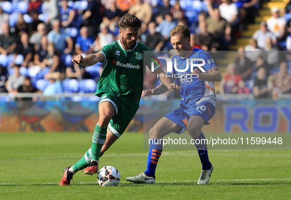 Aaron Jarvis of Yeovil Town Football Club tussles with Tom Conlon of Oldham Athletic Association Football Club during the Vanarama National...