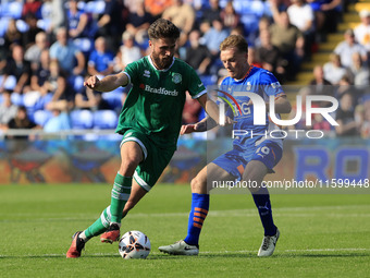 Aaron Jarvis of Yeovil Town Football Club tussles with Tom Conlon of Oldham Athletic Association Football Club during the Vanarama National...