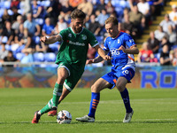 Aaron Jarvis of Yeovil Town Football Club tussles with Tom Conlon of Oldham Athletic Association Football Club during the Vanarama National...