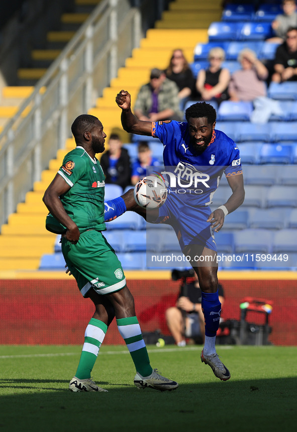 Emmanuel Monthe of Oldham Athletic Association Football Club tussles with Frank Nouble of Yeovil Town Football Club during the Vanarama Nati...