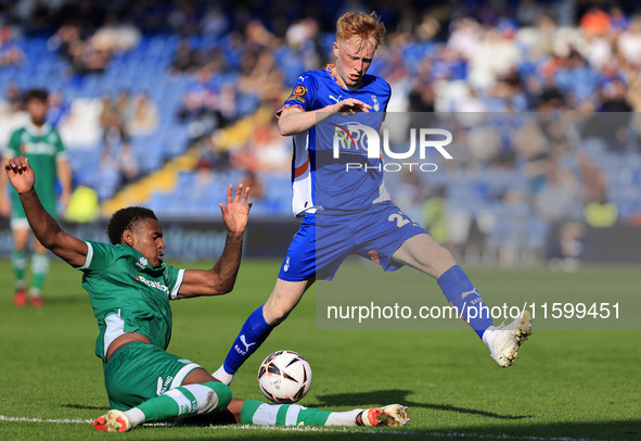 Oliver Hammond of Oldham Athletic Association Football Club tussles with Morgan Williams of Yeovil Town Football Club during the Vanarama Na...