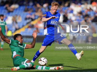 Oliver Hammond of Oldham Athletic Association Football Club tussles with Morgan Williams of Yeovil Town Football Club during the Vanarama Na...