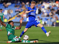 Oliver Hammond of Oldham Athletic Association Football Club tussles with Morgan Williams of Yeovil Town Football Club during the Vanarama Na...