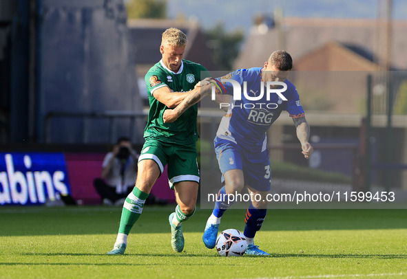 James Norwood of Oldham Athletic Association Football Club tussles with Jake Wannell of Yeovil Town Football Club during the Vanarama Nation...