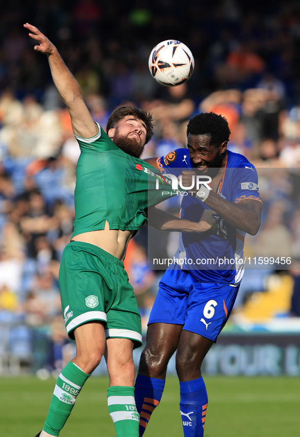 Emmanuel Monthe of Oldham Athletic Association Football Club tussles with Aaron Jarvis of Yeovil Town Football Club during the Vanarama Nati...