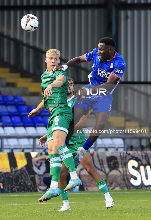 Mike Fondop of Oldham Athletic Association Football Club tussles with Jake Wannell of Yeovil Town Football Club during the Vanarama National...