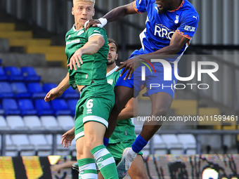 Mike Fondop of Oldham Athletic Association Football Club tussles with Jake Wannell of Yeovil Town Football Club during the Vanarama National...