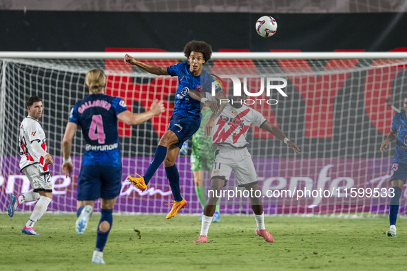 Axel Witsel of Atletico de Madrid (L) in action against Randy Nteka of Rayo Vallecano (R) during the La Liga EA Sports 2024/25 football matc...