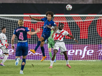 Axel Witsel of Atletico de Madrid (L) in action against Randy Nteka of Rayo Vallecano (R) during the La Liga EA Sports 2024/25 football matc...