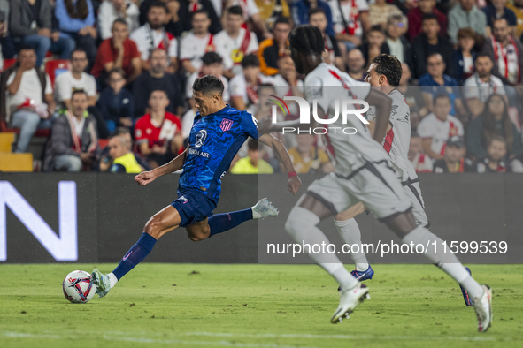 Nahuel Molina of Atletico de Madrid (L) in action with the ball during the La Liga EA Sports 2024/25 football match between Rayo Vallecano a...