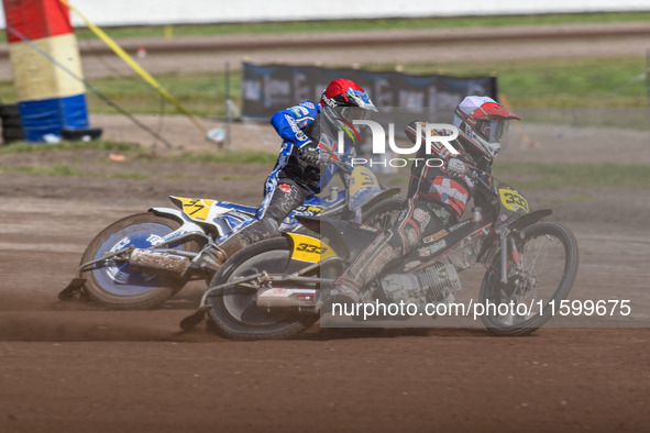 Kenneth Kruse Hansen (333) of Denmark in white leads Chris Harris (37) of Great Britain in red during the FIM Long Track World Championship...