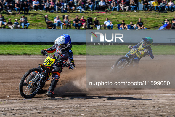 Zach Wajtknecht (109) of Great Britain in blue leads Mathias Tresarrieu (27) of France in green during the FIM Long Track World Championship...