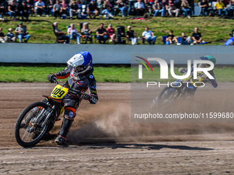 Zach Wajtknecht (109) of Great Britain in blue leads Mathias Tresarrieu (27) of France in green during the FIM Long Track World Championship...