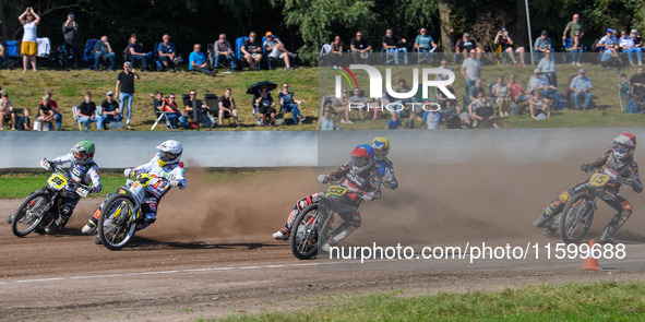 Kenneth Kruse Hansen (333) of Denmark in blue rides inside Martin Smolinski (84) of Germany in white, Hynek Stichauer (86) of Czech Republic...