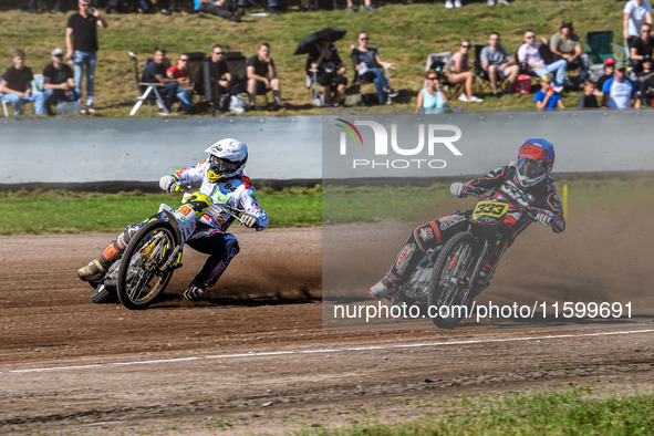 Kenneth Kruse Hansen (333) of Denmark in blue rides inside Martin Smolinski (84) of Germany in white during the FIM Long Track World Champio...