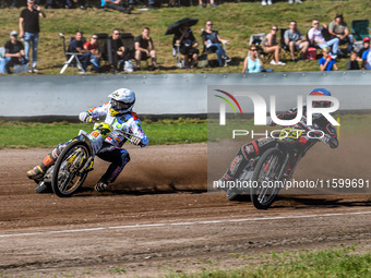 Kenneth Kruse Hansen (333) of Denmark in blue rides inside Martin Smolinski (84) of Germany in white during the FIM Long Track World Champio...