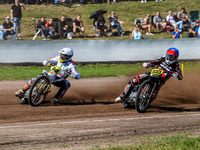 Kenneth Kruse Hansen (333) of Denmark in blue rides inside Martin Smolinski (84) of Germany in white during the FIM Long Track World Champio...