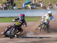 Kenneth Kruse Hansen (333) of Denmark in blue leads Martin Smolinski (84) of Germany in white during the FIM Long Track World Championship F...