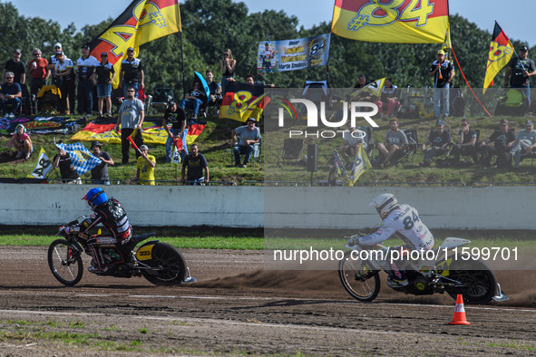 Kenneth Kruse Hansen (333) of Denmark in blue leads Martin Smolinski (84) of Germany in white during the FIM Long Track World Championship F...