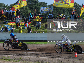 Kenneth Kruse Hansen (333) of Denmark in blue leads Martin Smolinski (84) of Germany in white during the FIM Long Track World Championship F...