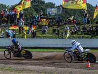 Kenneth Kruse Hansen (333) of Denmark in blue leads Martin Smolinski (84) of Germany in white during the FIM Long Track World Championship F...