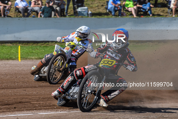 Kenneth Kruse Hansen (333) of Denmark in blue leads Martin Smolinski (84) of Germany in white during the FIM Long Track World Championship F...