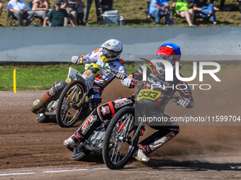 Kenneth Kruse Hansen (333) of Denmark in blue leads Martin Smolinski (84) of Germany in white during the FIM Long Track World Championship F...