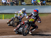 Kenneth Kruse Hansen (333) of Denmark in blue leads Martin Smolinski (84) of Germany in white during the FIM Long Track World Championship F...