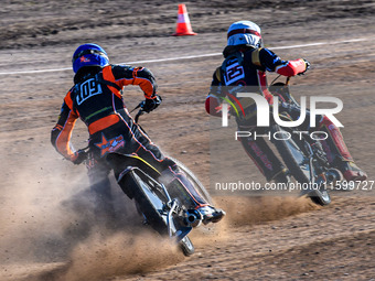 Zach Wajtknecht (109) of Great Britain in blue chases Lukas Fienhage (125) of Germany in white during the FIM Long Track World Championship...