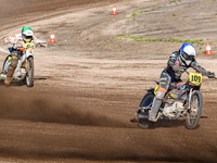 Zach Wajtknecht (109) of Great Britain in blue leads Martin Smolinski (84) of Germany in green during the FIM Long Track World Championship...