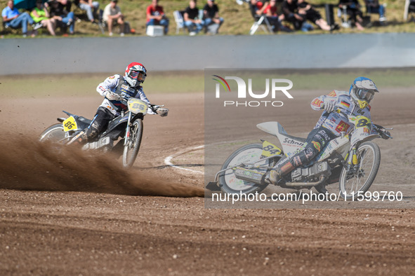 Martin Smolinski (84) of Germany in blue leads Hynek Stichauer (86) of the Czech Republic in red during the FIM Long Track World Championshi...