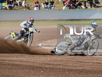 Martin Smolinski (84) of Germany in blue leads Hynek Stichauer (86) of the Czech Republic in red during the FIM Long Track World Championshi...