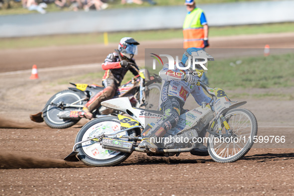 Martin Smolinski (84) of Germany in blue leads Lukas Fienhage (125) of Germany in white during the FIM Long Track World Championship Final 5...