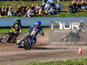 Chris Harris (37) of Great Britain in blue rides inside Mika Meijer (54) of the Netherlands in green with Hynek Stichauer (86) of the Czech...