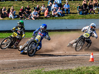 Chris Harris (37) of Great Britain in blue rides inside Mika Meijer (54) of the Netherlands in green with Hynek Stichauer (86) of the Czech...