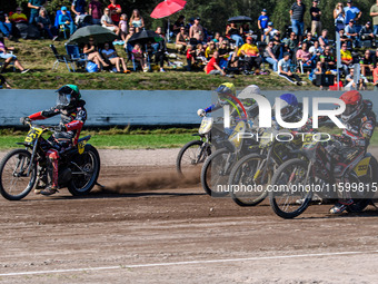 Lukas Fienhage (125) of Germany in green leads the pack of riders during the FIM Long Track World Championship Final 5 at the Speed Centre R...