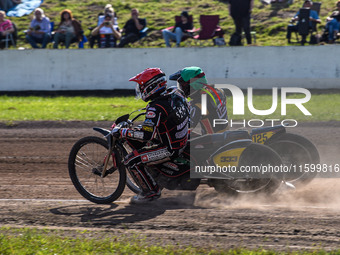 Kenneth Kruse Hansen (333) of Denmark in red rides inside Lukas Fienhage (125) of Germany in green during the FIM Long Track World Champions...