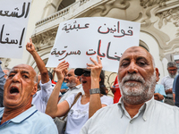 A female demonstrator shouts slogans as she raises a placard that reads in Arabic, ''absurd laws, theatrics elections,'' during a demonstrat...