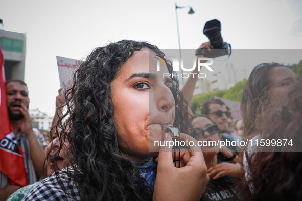 A young female demonstrator blows a whistle during a demonstration organized by the Tunisian Network for Rights and Freedoms in Tunis, Tunis...